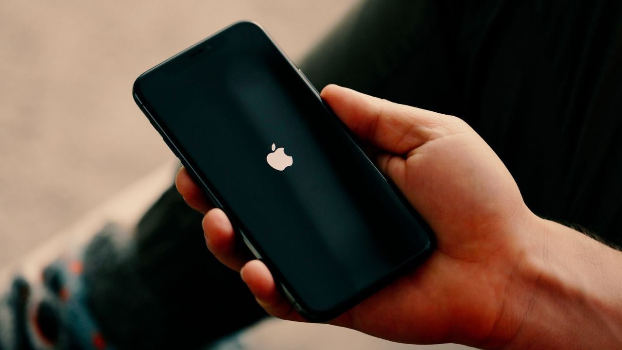 A person holding a modern iPhone showcasing the vibrant screen